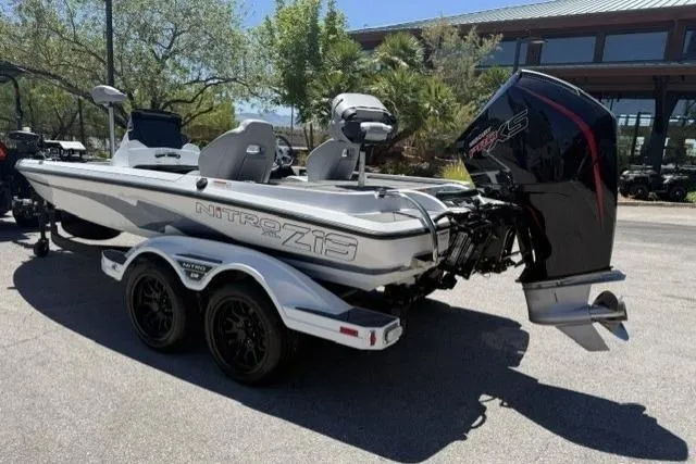 Slide: The Image of 2026 Nitro Z19 XL boat with dual axle trailer, parked outdoors. - 2