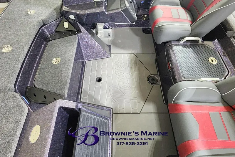Slide: The Image of 2026 Ranger Z521 boat interior with red and gray seats, branded flooring, and storage compartments. - 7