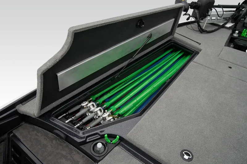 Slide: The Image of Interior storage compartment of 2026 Nitro Z20 XL Pro boat, featuring rod holders and carpeted finish. - 23