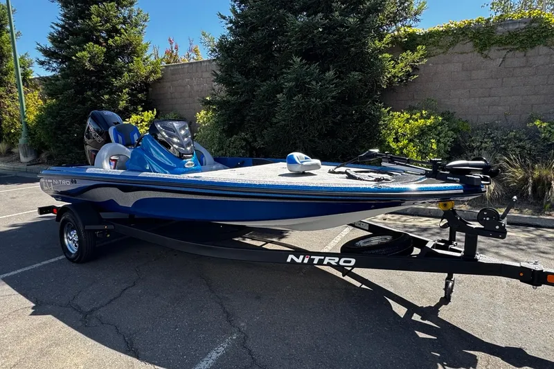 Slide: The Image of 2026 Nitro Z17 boat in blue, parked on a trailer in a sunny outdoor setting. - 3