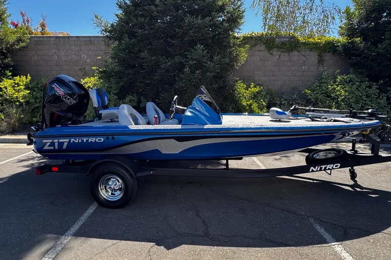 The Image of 2026 Nitro Z17 boat in blue, parked outdoors on a trailer. - 0