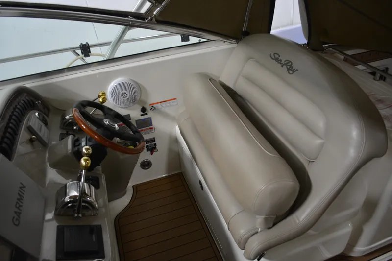 Slide: The Image of 2006 Sea Ray 290 Amberjack helm with steering wheel and beige seating. - 13