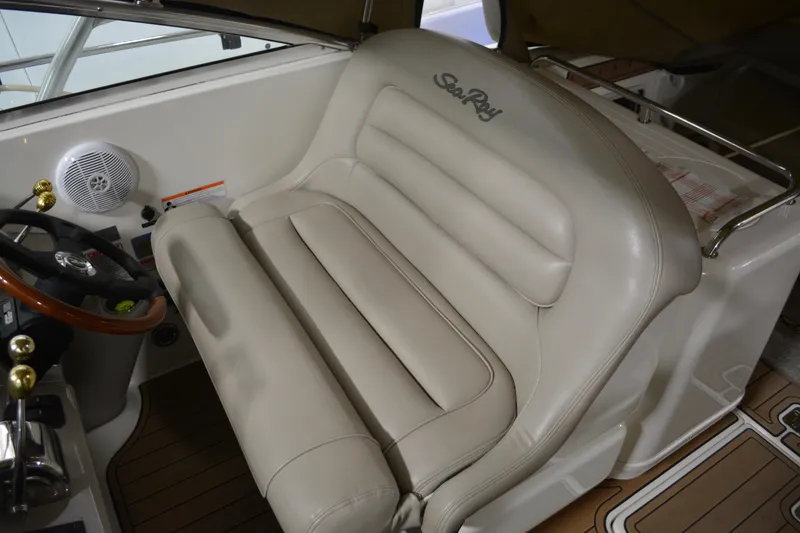 Slide: The Image of 2006 Sea Ray 290 Amberjack helm with beige leather seating and wooden steering wheel. - 14