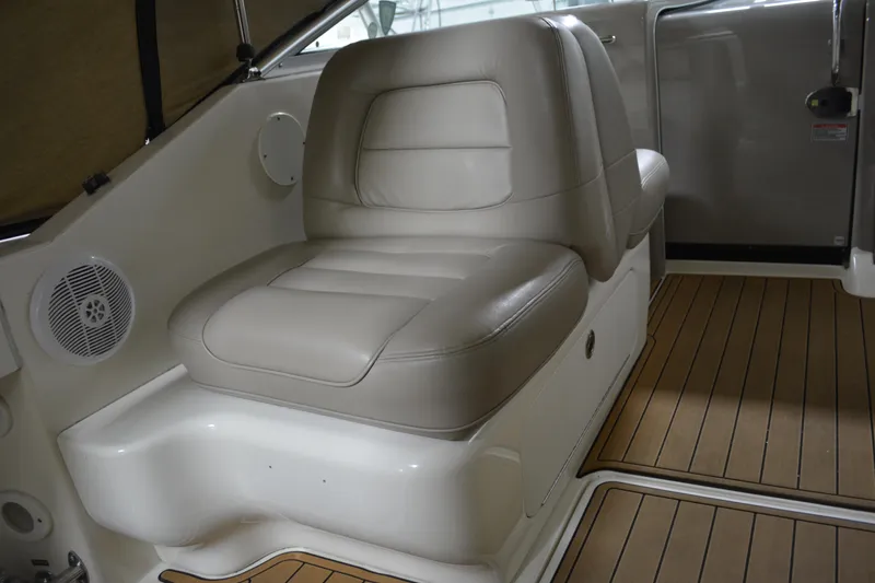 Slide: The Image of 2006 Sea Ray 290 Amberjack interior with beige leather seating and wood flooring. - 16