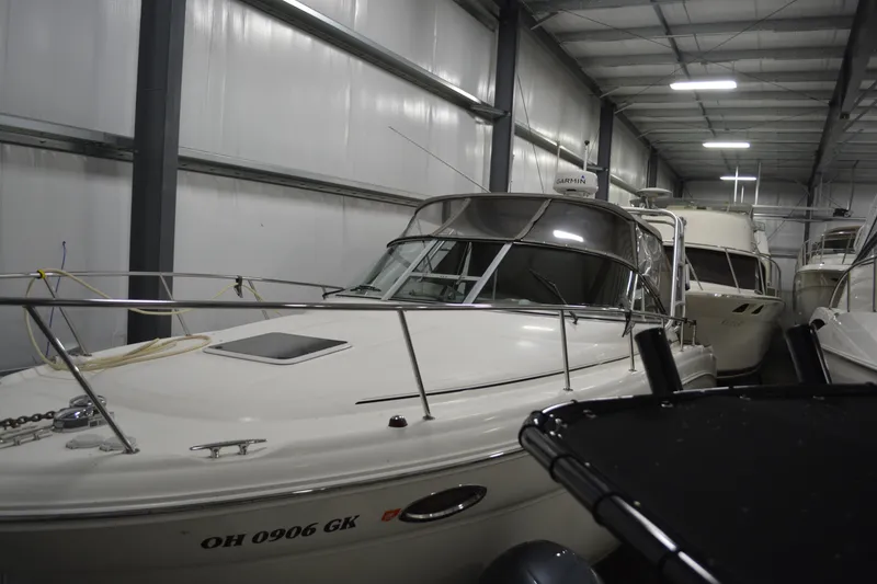 Slide: The Image of 2006 Sea Ray 290 Amberjack boat stored indoors, showcasing sleek design and sturdy build. - 2