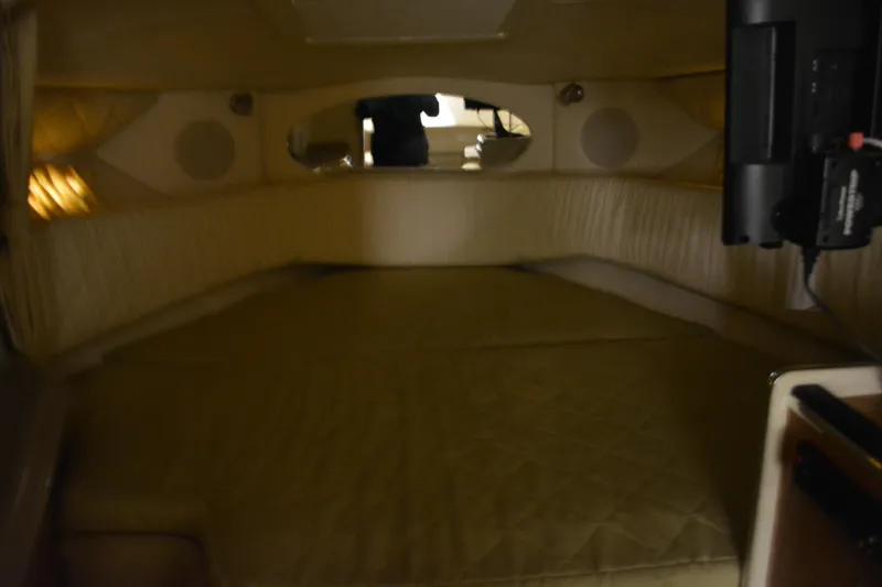 Slide: The Image of Interior cabin of 2006 Sea Ray 290 Amberjack boat, featuring a cozy sleeping area. - 23