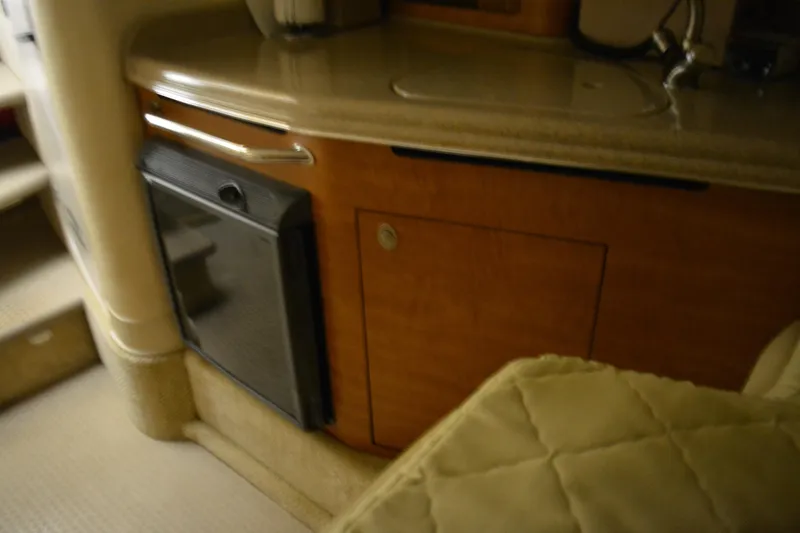 Slide: The Image of 2006 Sea Ray 290 Amberjack interior with kitchenette and cabinetry. - 28