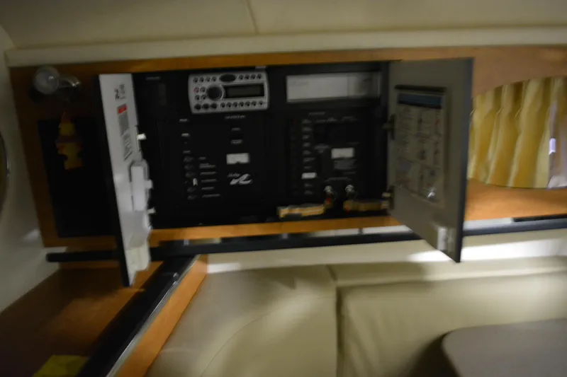 Slide: The Image of Electrical panel inside 2006 Sea Ray 290 Amberjack boat cabin with open cabinet doors. - 30