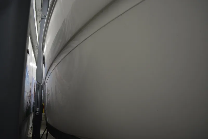 Slide: The Image of 2006 Sea Ray 290 Amberjack boat hull in storage, close-up view. - 4