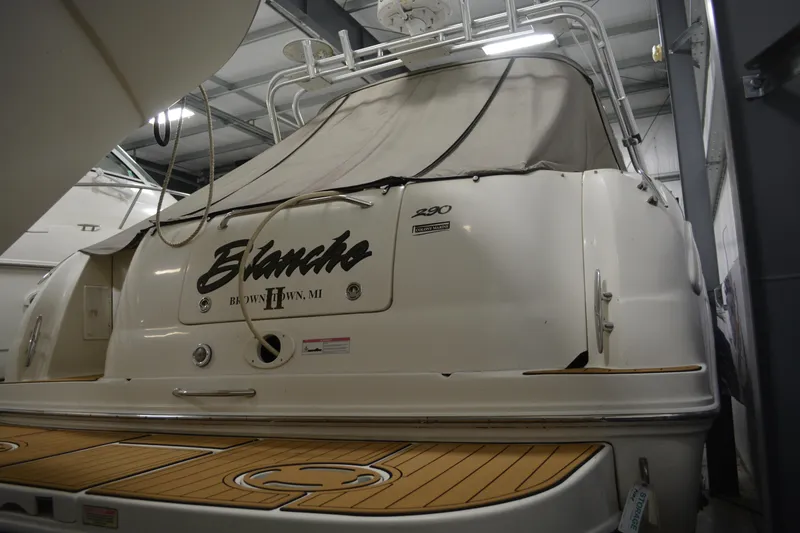Slide: The Image of 2006 Sea Ray 290 Amberjack boat in storage, rear view with name "Blanche." - 7