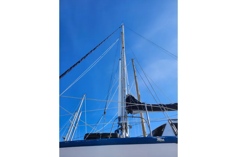 Slide: The Image of Sailboat mast and rigging against clear blue sky, Gilbert Caroff Exploration 1987. - 10