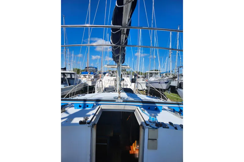 Slide: The Image of Sailboat docked in marina, Gilbert Caroff Exploration model, 1987, with clear blue sky. - 17