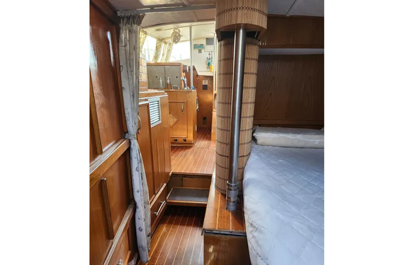 Slide: The Image of Interior of 1987 Gilbert Caroff Exploration yacht, featuring wooden furnishings and cozy cabin space. - 29