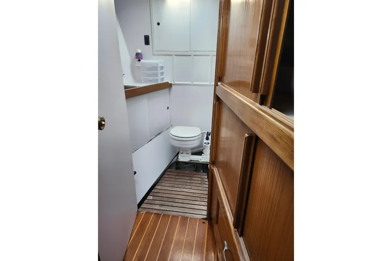 Slide: The Image of Nautical bathroom interior of 1987 Gilbert Caroff Exploration boat, featuring wooden accents and compact design. - 34