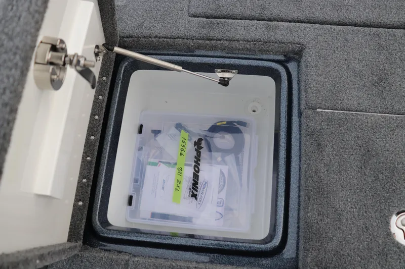 Slide: The Image of Open storage compartment in 2026 Phoenix 721 ZXL boat with organized contents. - 11