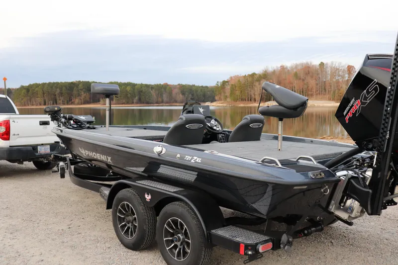 Slide: The Image of 2026 Phoenix 721 ZXL boat on trailer by lake, ready for fishing adventure. - 15