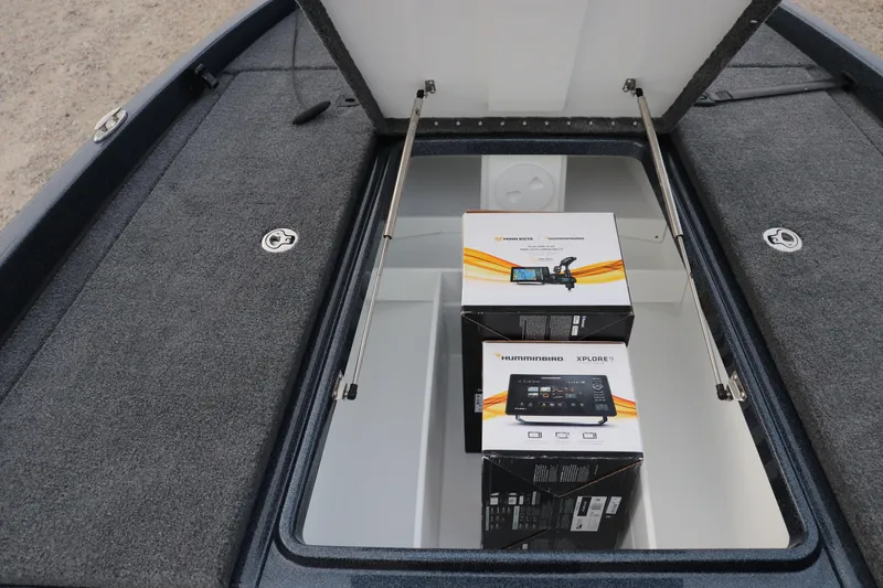 Slide: The Image of Open storage compartment in 2026 Phoenix 721 ZXL boat with electronic equipment boxes. - 3