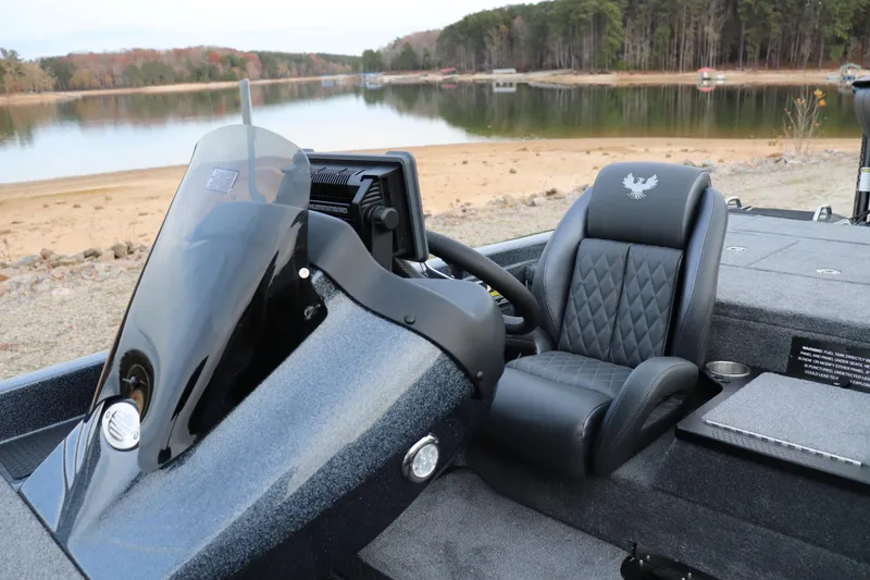 Slide: The Image of 2026 Phoenix 721 ZXL boat interior with steering wheel and luxurious seating by a serene lake. - 5