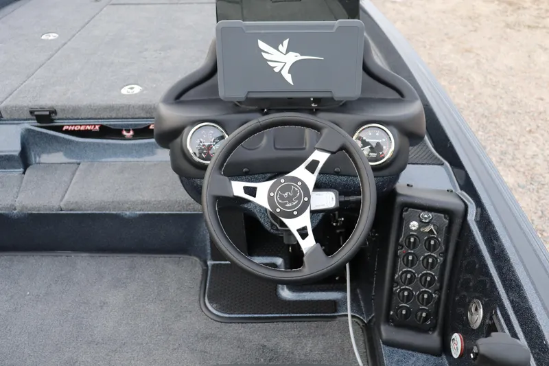 Slide: The Image of 2026 Phoenix 721 ZXL boat dashboard with steering wheel and control panel. - 6