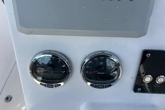 Slide: The Image of Dashboard of 2018 Pro-Line 23 Dual Console boat with gauges and controls. - 14