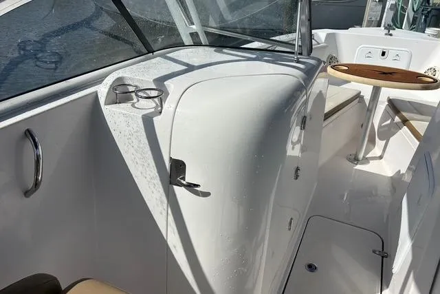 Slide: The Image of 2018 Pro-Line 23 Dual Console boat interior with seating and table. - 17