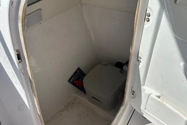 Slide: The Image of 2018 Pro-Line 23 Dual Console boat interior with portable toilet. - 18