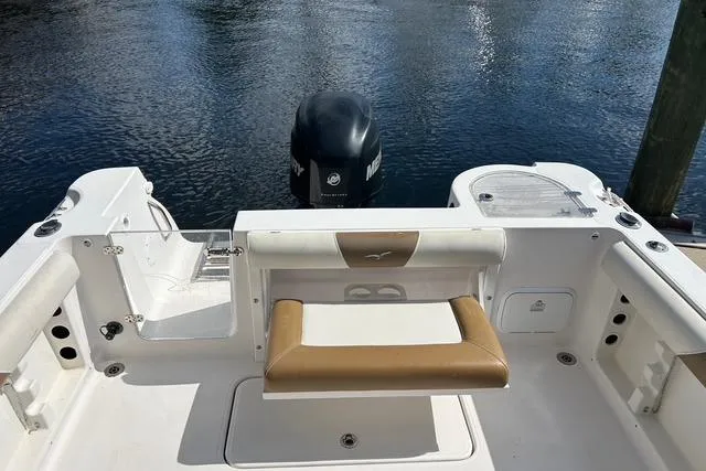 Slide: The Image of 2018 Pro-Line 23 Dual Console boat with seating and outboard motor on calm water. - 19