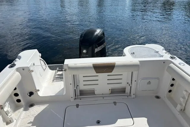 Slide: The Image of 2018 Pro-Line 23 Dual Console boat with Mercury engine on calm water. - 24