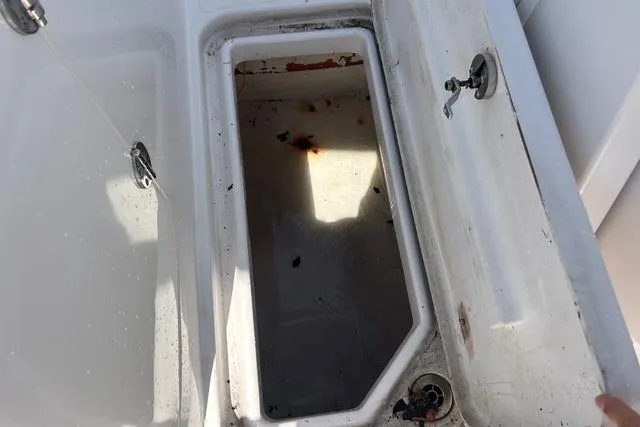 Slide: The Image of Open storage compartment on 2018 Pro-Line 23 Dual Console boat, showing interior details. - 26
