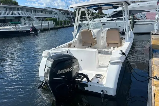 Slide: The Image of 2018 Pro-Line 23 Dual Console boat docked with Mercury outboard engine. - 3