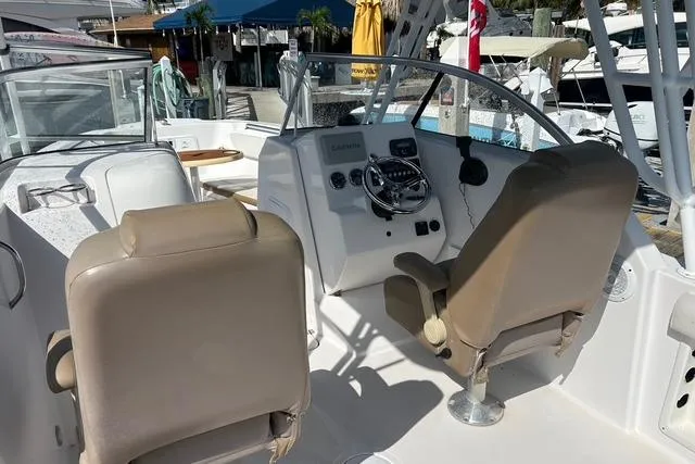 Slide: The Image of 2018 Pro-Line 23 Dual Console boat interior with helm and seating. - 5