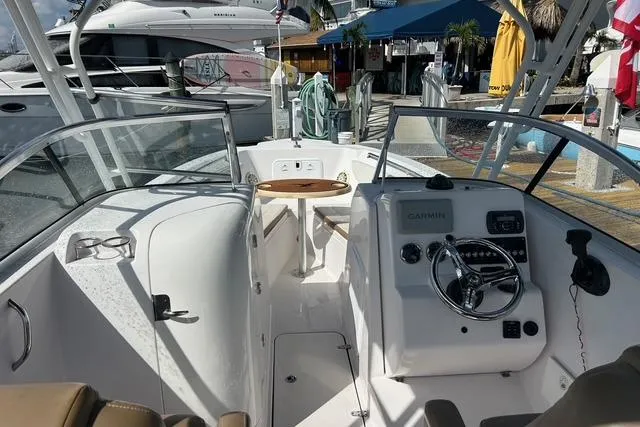 Slide: The Image of 2018 Pro-Line 23 Dual Console boat interior with steering wheel and seating area. - 6