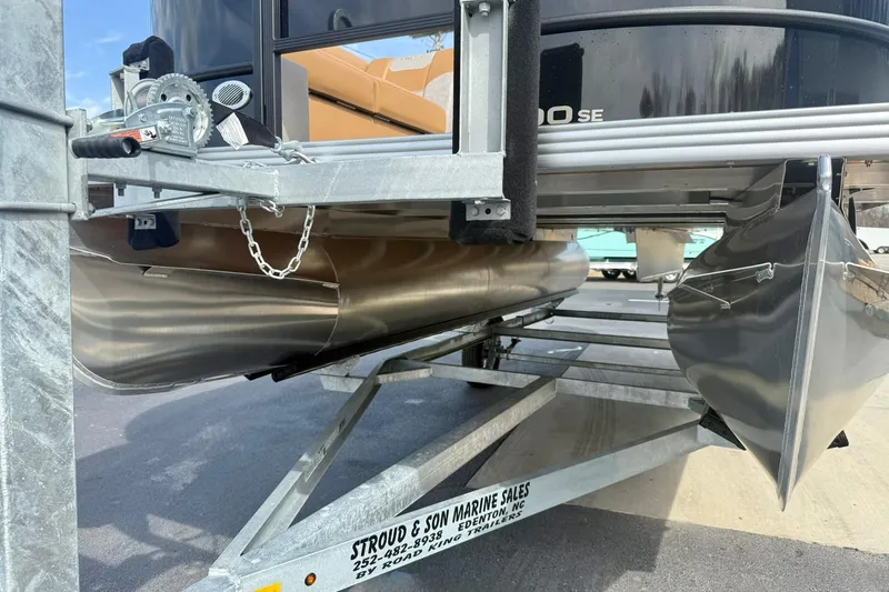 Slide: The Image of 2026 Crest Conquest SE 200 Fish pontoon boat on trailer, showcasing undercarriage and pontoons. - 10