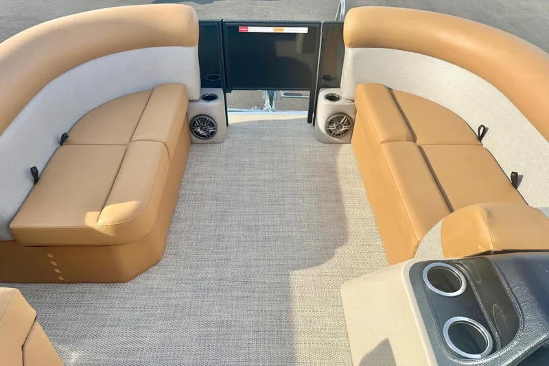 Slide: The Image of 2026 Crest Conquest SE 200 Fish boat interior with tan seating and cup holders. - 11