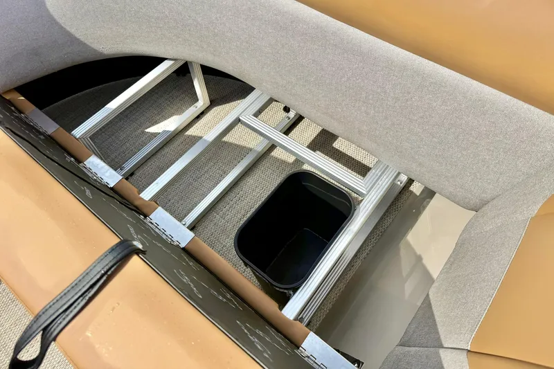 Slide: The Image of Interior view of 2026 Crest Conquest SE 200 Fish boat seating and storage area. - 14