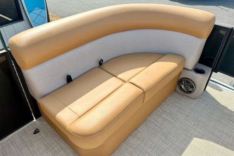 Slide: The Image of 2026 Crest Conquest SE 200 Fish boat interior with tan seating and speaker. - 15
