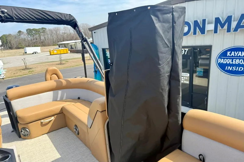 Slide: The Image of 2026 Crest Conquest SE 200 Fish boat interior with tan seating and black canopy. - 19