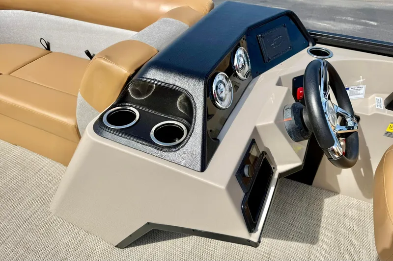 Slide: The Image of 2026 Crest Conquest SE 200 Fish boat dashboard with steering wheel and cup holders. - 20