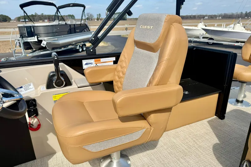 Slide: The Image of Captain's chair in 2026 Crest Conquest SE 200 Fish boat, featuring tan upholstery. - 24