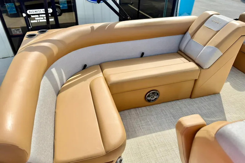 Slide: The Image of 2026 Crest Conquest SE 200 Fish boat interior with tan seating and speaker. - 29