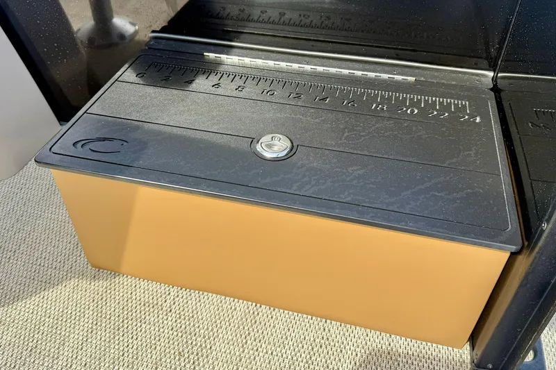 Slide: The Image of 2026 Crest Conquest SE 200 Fish storage compartment with measuring scale on lid. - 30