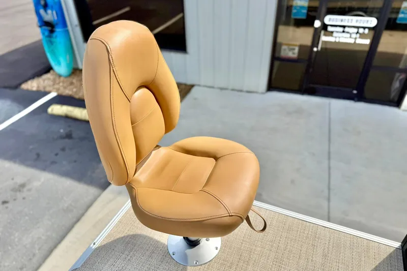Slide: The Image of Tan boat seat on Crest Conquest SE 200 Fish, 2026 model, outdoor setting. - 33