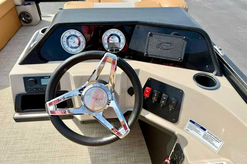 Slide: The Image of 2026 Crest Conquest SE 200 Fish boat dashboard with steering wheel and gauges. - 4