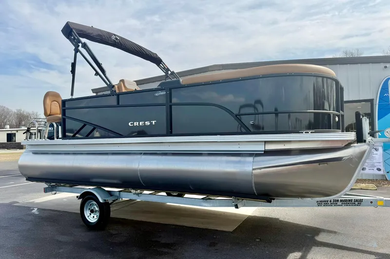Slide: The Image of 2026 Crest Conquest SE 200 Fish pontoon boat on trailer, outdoor display. - 7