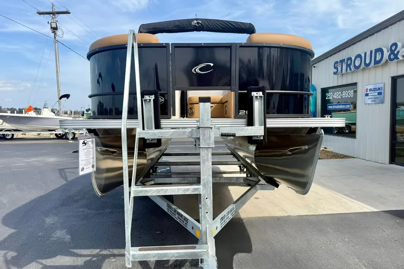 Slide: The Image of 2026 Crest Conquest SE 200 Fish pontoon boat displayed at dealership. - 9