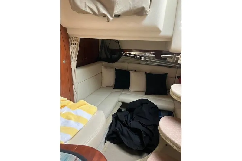 Slide: The Image of 2007 Sea Ray 320 Sundancer cabin interior with cozy seating and cushions. - 10