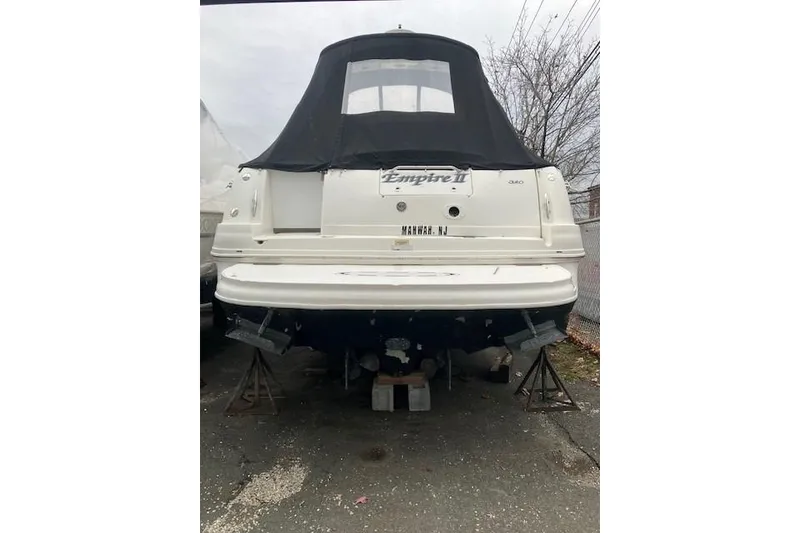 Slide: The Image of 2007 Sea Ray 320 Sundancer boat on stands, covered, rear view. - 2