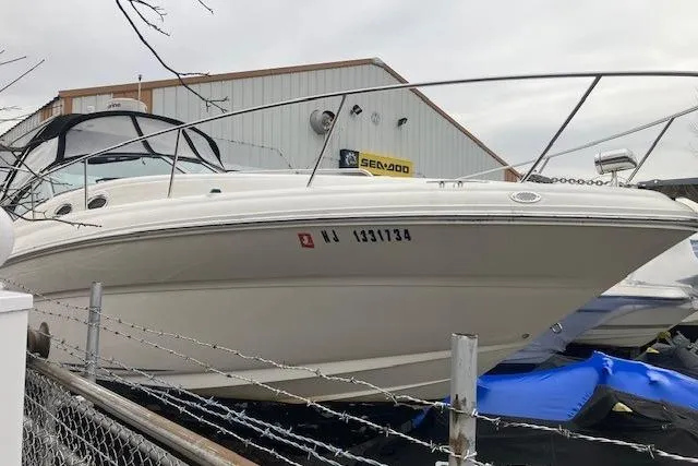 Slide: The Image of 2007 Sea Ray 320 Sundancer boat docked near a warehouse. - 3