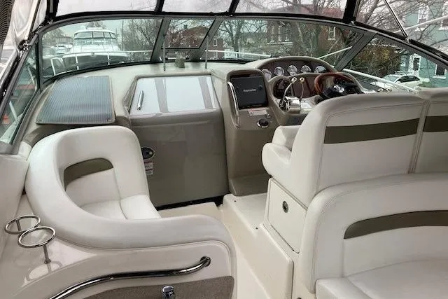 Slide: The Image of 2007 Sea Ray 320 Sundancer boat interior with helm and seating area. - 4