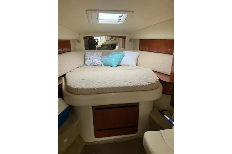 Slide: The Image of Cozy cabin interior of 2007 Sea Ray 320 Sundancer with bed and cushions. - 9
